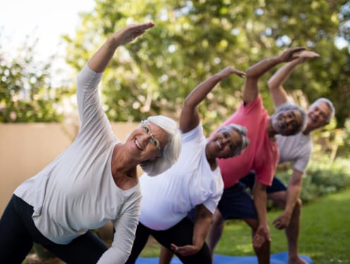 Diverse group of seniors stretching in the park