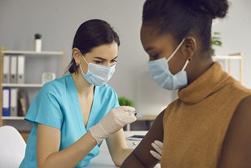 nurse giving a vaccine 