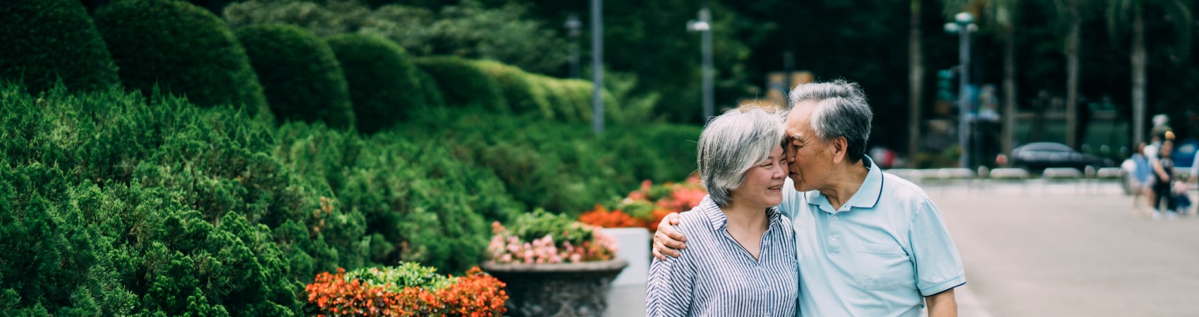 happy senior couple walking in park